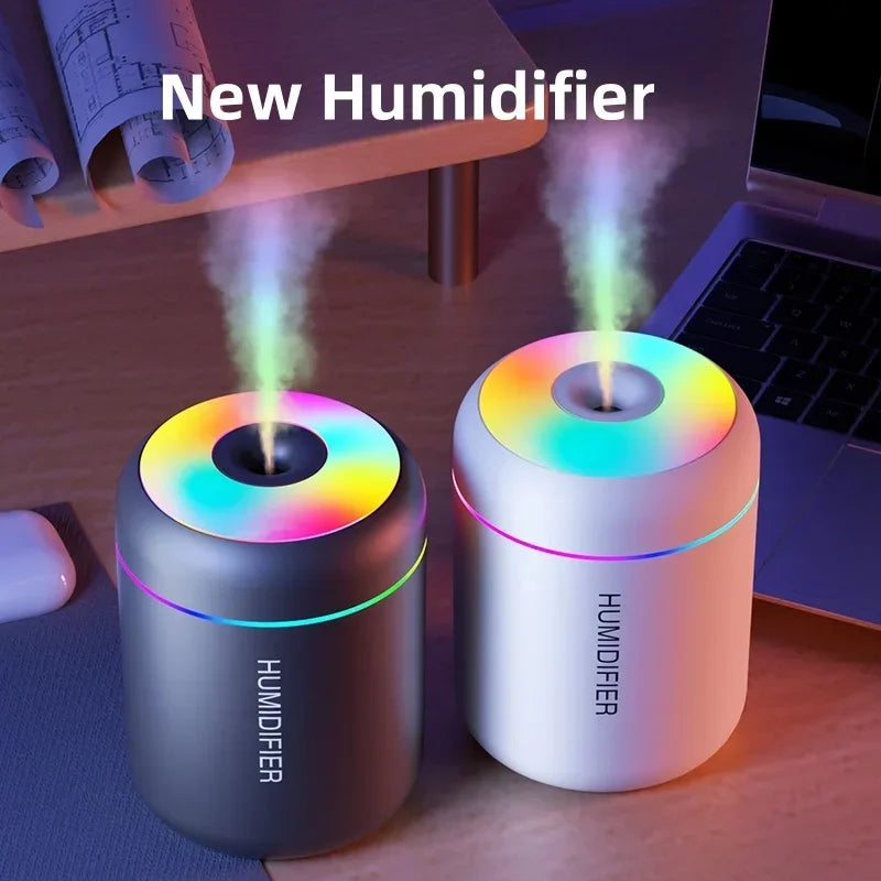 Rainbow LED humidifiers on desk near laptop, Zaranss home essentials